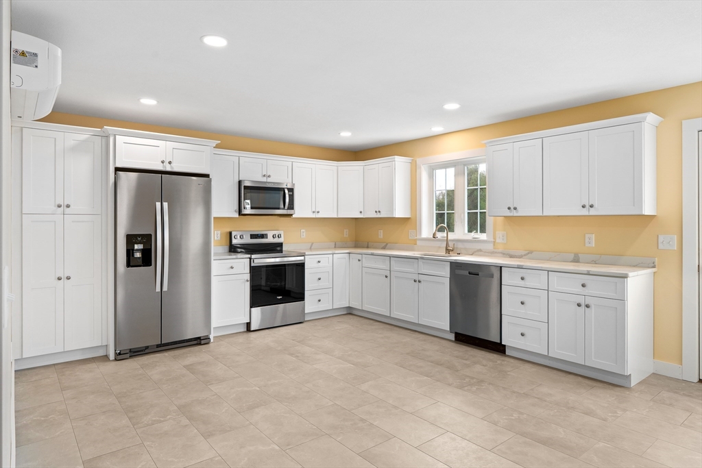 10 Glen Cove Place, Unit A Easthampton, MA 01027 - Photo 12 of 39 a large kitchen with cabinets stainless steel appliances and a window