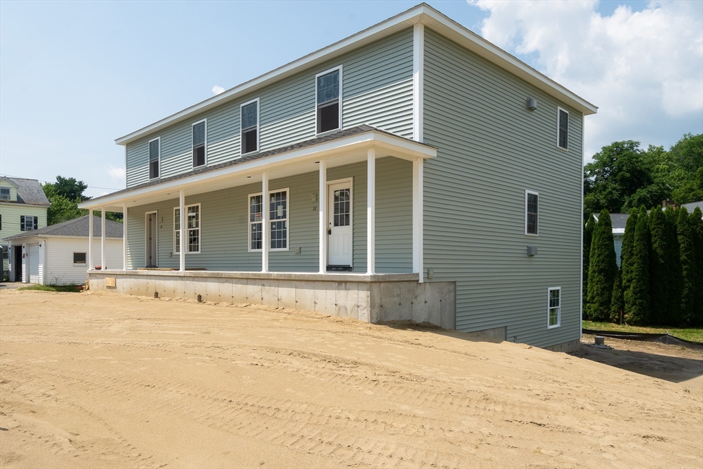 10 Glen Cove Place, Unit A Easthampton, MA 01027 - Photo 2 of 39 a front view of a house with a yard and garage