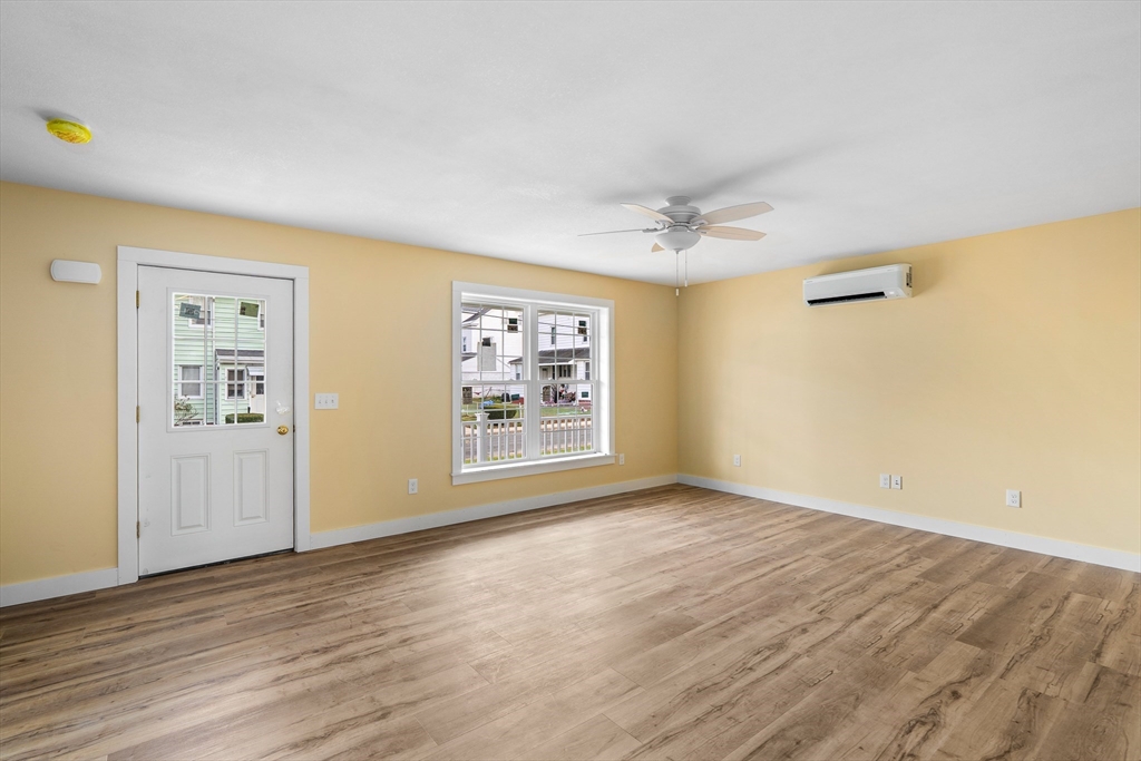10 Glen Cove Place, Unit A Easthampton, MA 01027 - Photo 6 of 39 a view of an empty room with a window and wooden floor
