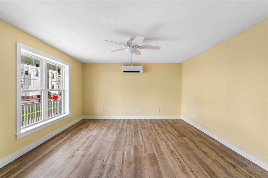 10 Glen Cove Place, Unit A Easthampton, MA 01027 - Photo 7 of 39 wooden floor in an empty room with a window