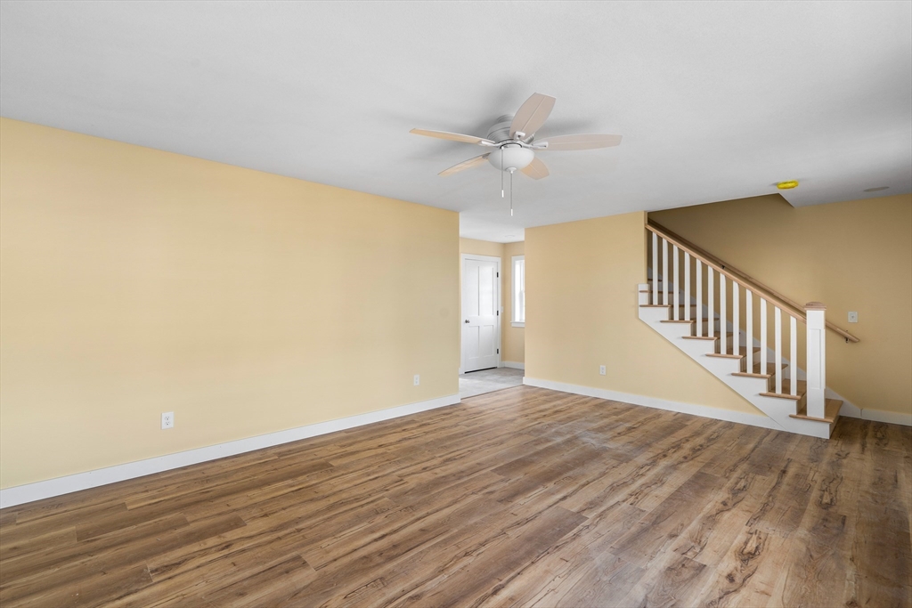 10 Glen Cove Place, Unit A Easthampton, MA 01027 - Photo 8 of 39 a view of an empty room with wooden floor and a ceiling fan