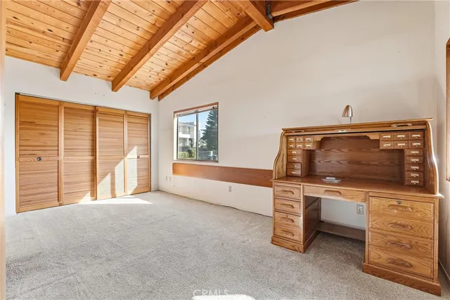 a view of a house with a small yard and potted plants