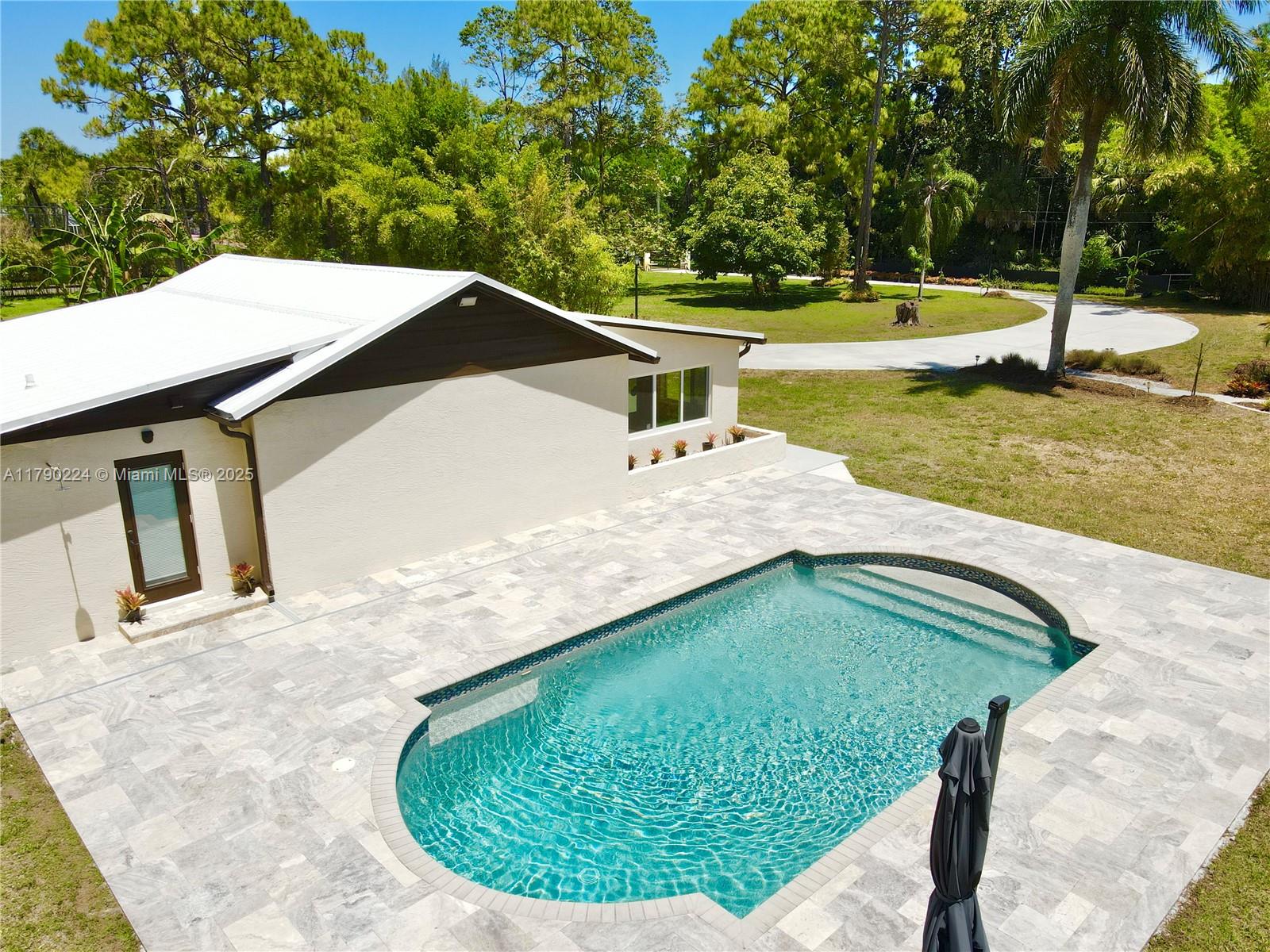 7219 Wilson Road West Palm Beach, FL 33413 - Photo 15 of 77 a view of a swimming pool with a yard