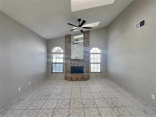 a view of an empty room with a fireplace