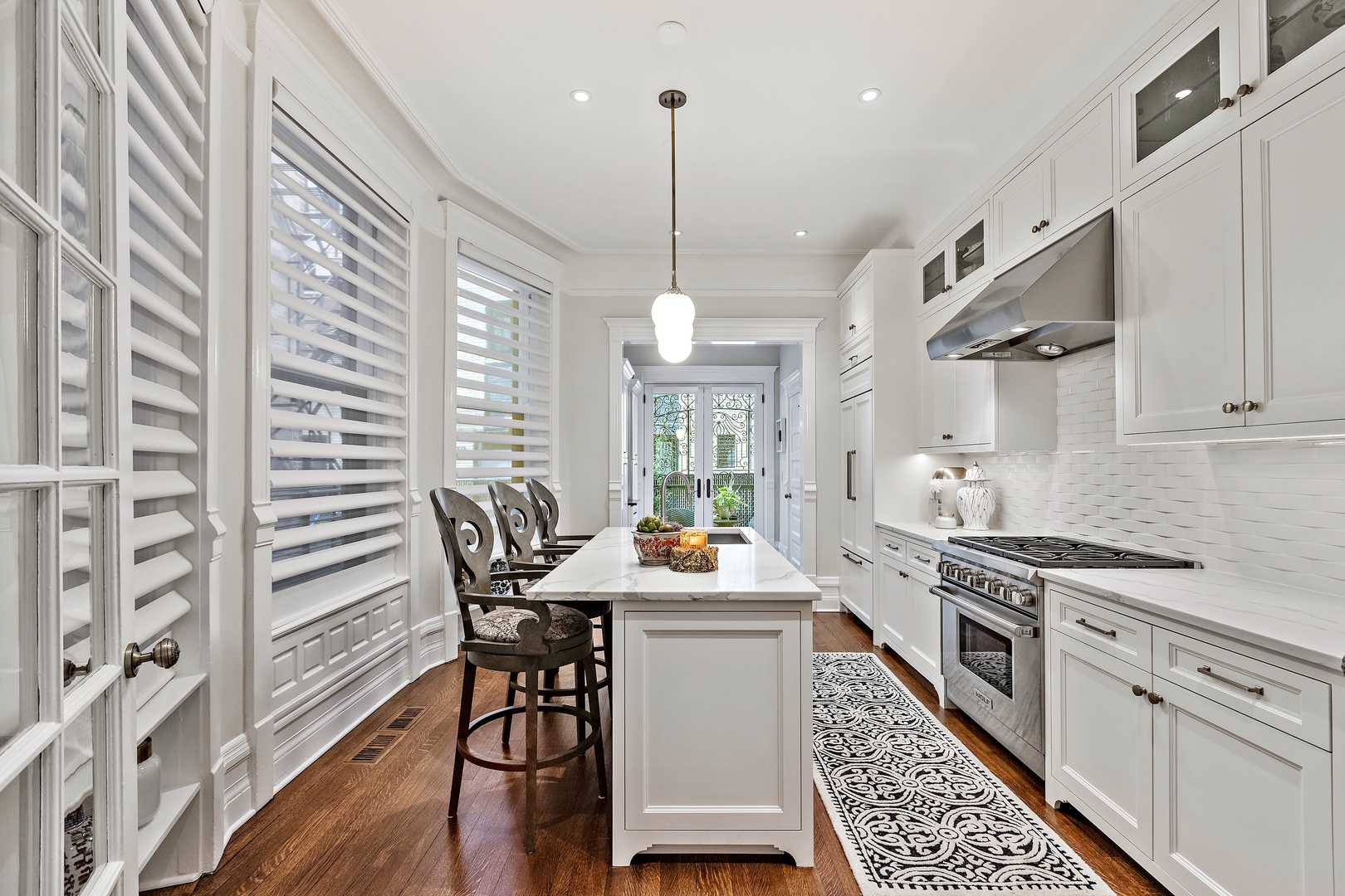 1304 North Ritchie Court Chicago, IL 60610 - Photo 15 of 39 a kitchen with stainless steel appliances kitchen island a hardwood floor and a sink