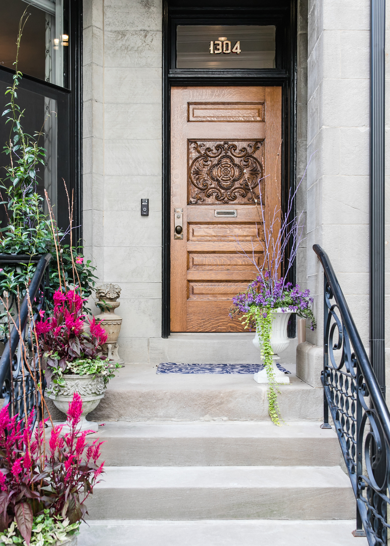 1304 North Ritchie Court Chicago, IL 60610 - Photo 2 of 39 a front view of a house with a flower garden