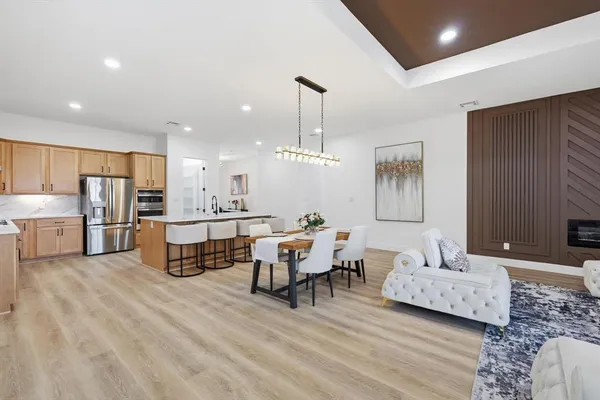 a living room with furniture and kitchen view