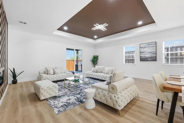 a living room with furniture and a wooden floor