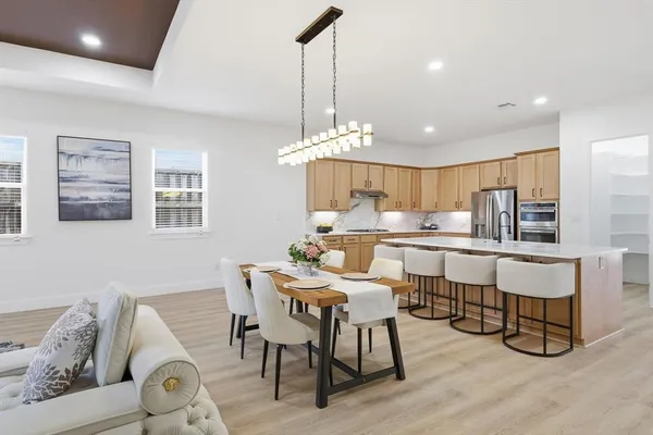 a view of a dining room with furniture and chandelier