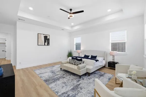 a living room with furniture and a ceiling fan