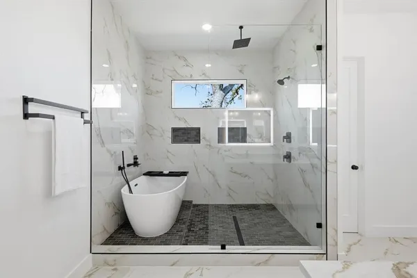 a bathroom with a bathtub and shower