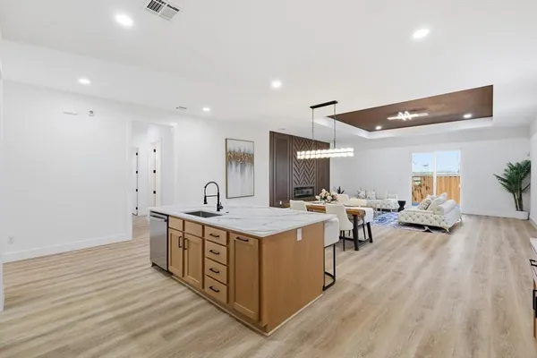 a open kitchen with stainless steel appliances granite countertop a lot of counter space and wooden floors