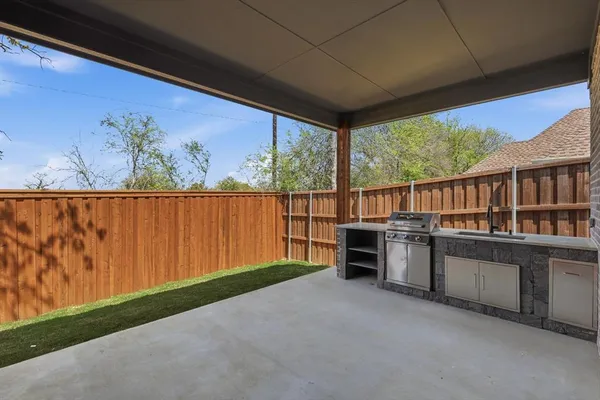 a view of a porch with furniture and garden
