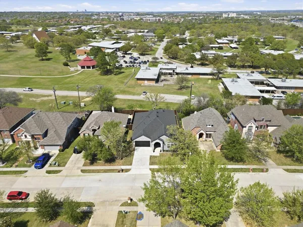 an aerial view of residential houses with outdoor space