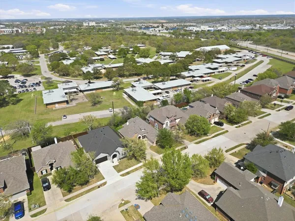 an aerial view of residential houses with outdoor space