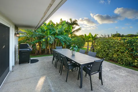 a backyard of a house with table and chairs