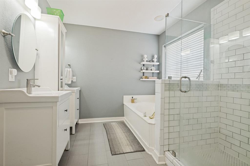 11709 Harbor Road Frisco, TX 75035 - Photo 11 of 12 a bathroom with a double vanity sink a mirror and bathtub