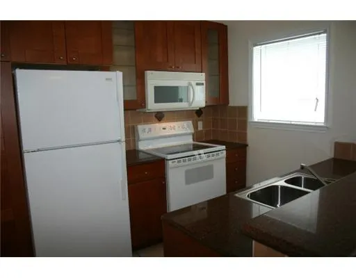 a kitchen with a refrigerator and a sink