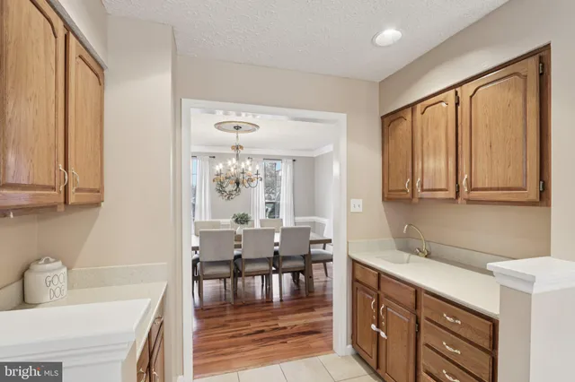 a kitchen with kitchen island granite countertop a table and chairs in it