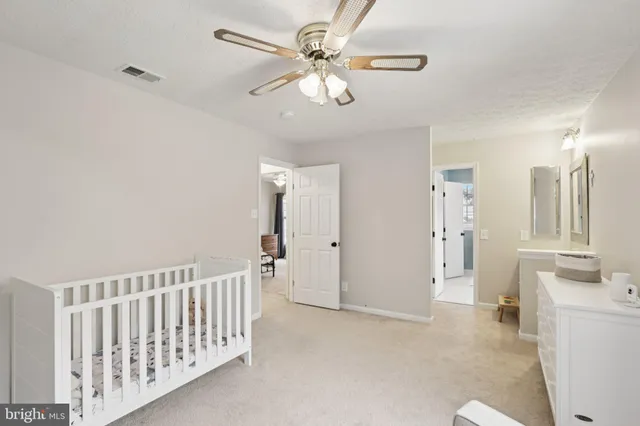 a living room with furniture and a dining table