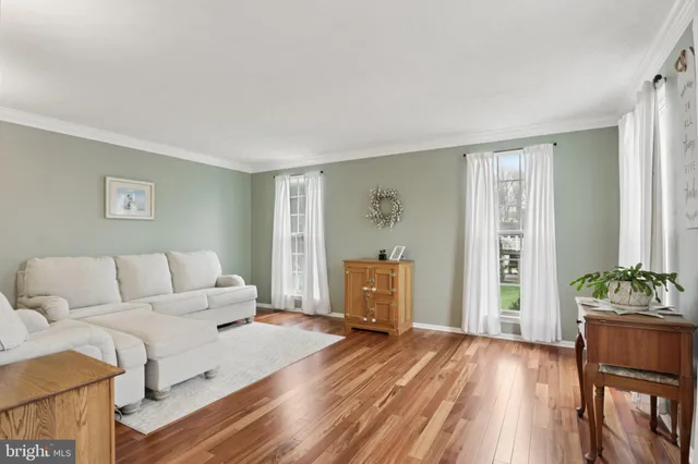 a view of a dining room with furniture wooden floor and chandelier