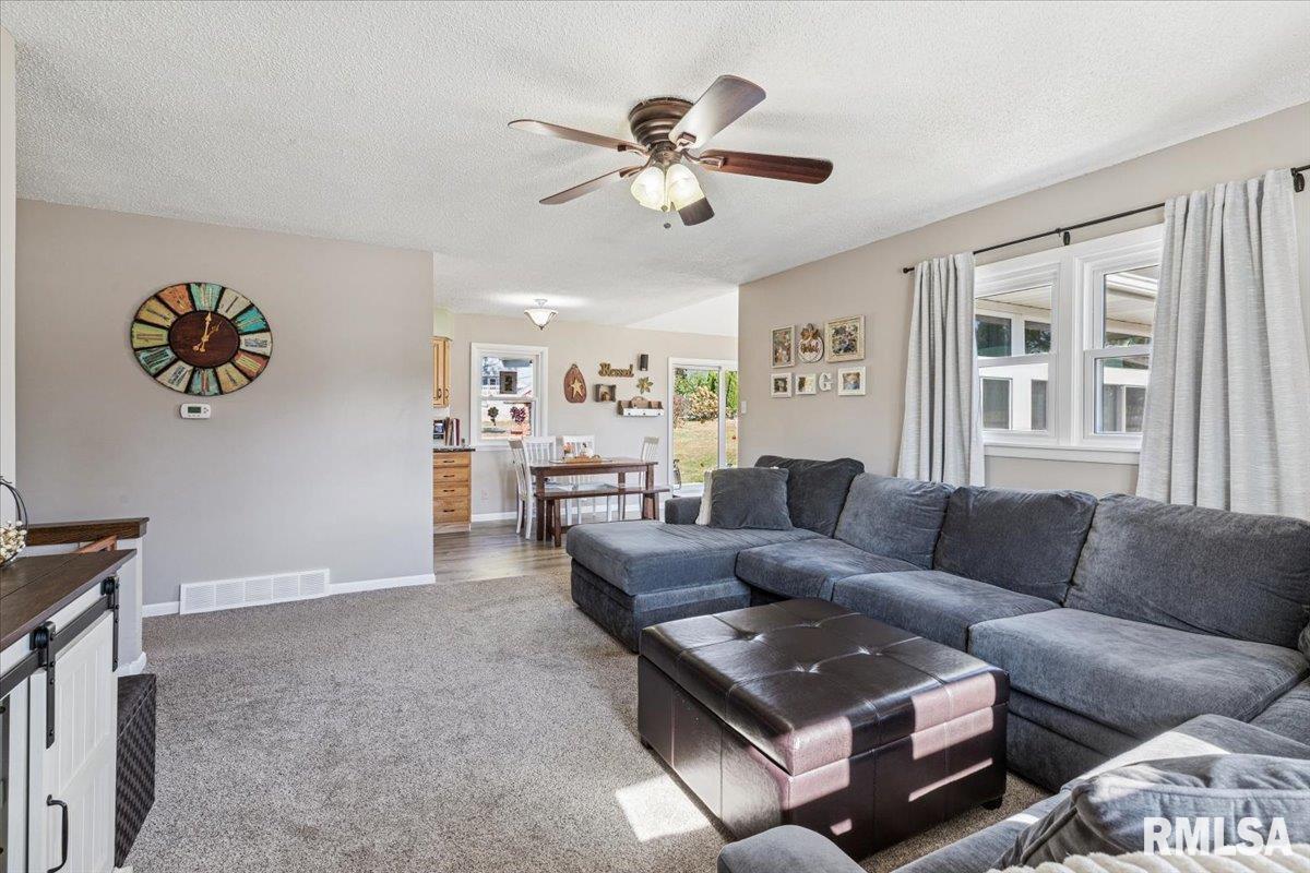 1146 6th Avenue North Clinton, IA 52732 - Photo 11 of 27 a living room with furniture and a large window