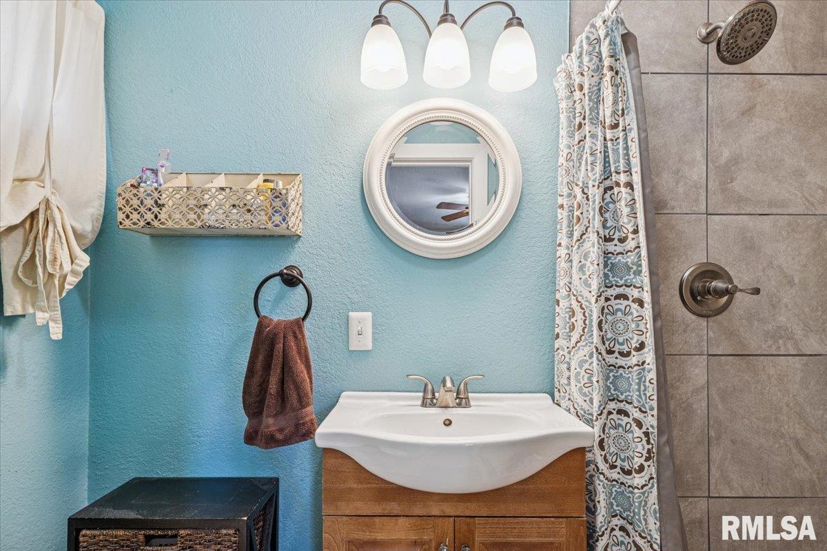 1146 6th Avenue North Clinton, IA 52732 - Photo 17 of 27 a bathroom with a sink and a mirror