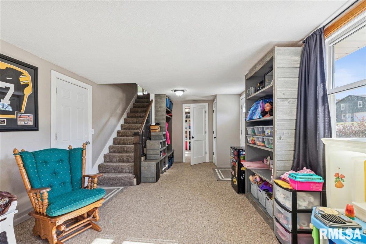 1146 6th Avenue North Clinton, IA 52732 - Photo 22 of 27 a living room with furniture a rug and a wall painting