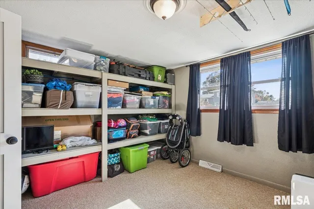 a room with lots of books and a large window