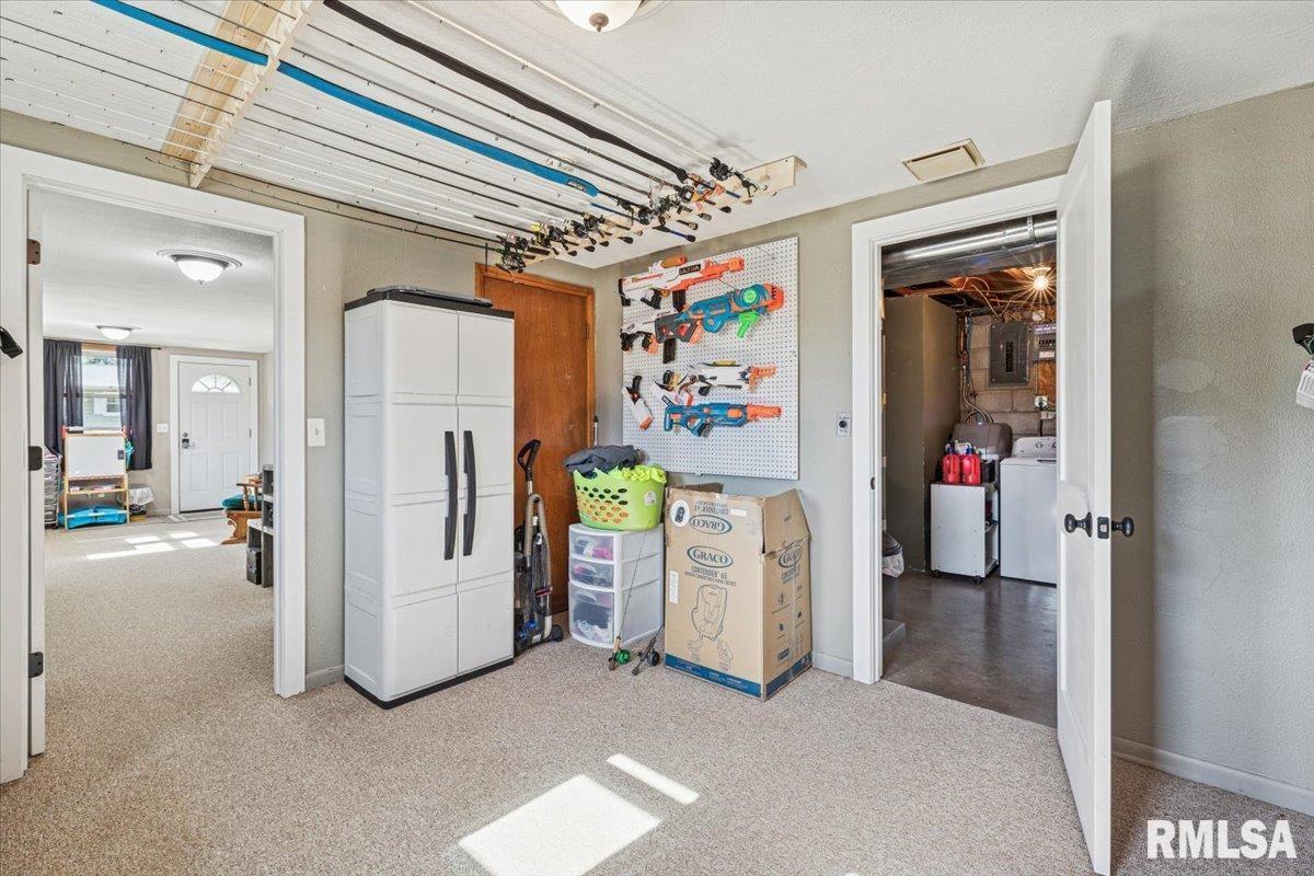 1146 6th Avenue North Clinton, IA 52732 - Photo 24 of 27 a view of a hallway with furniture and a refrigerator