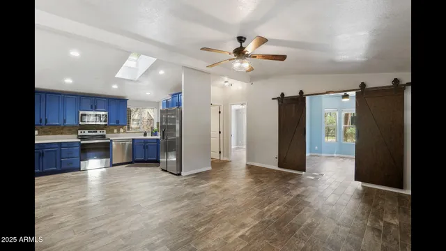 a kitchen with granite countertop wooden cabinets and stainless steel appliances