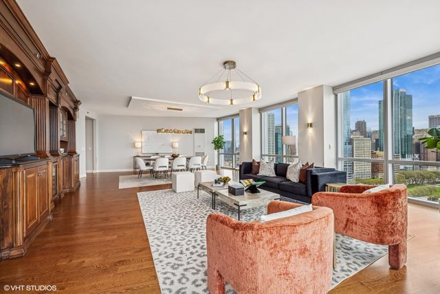 a living room with fireplace furniture and a large window