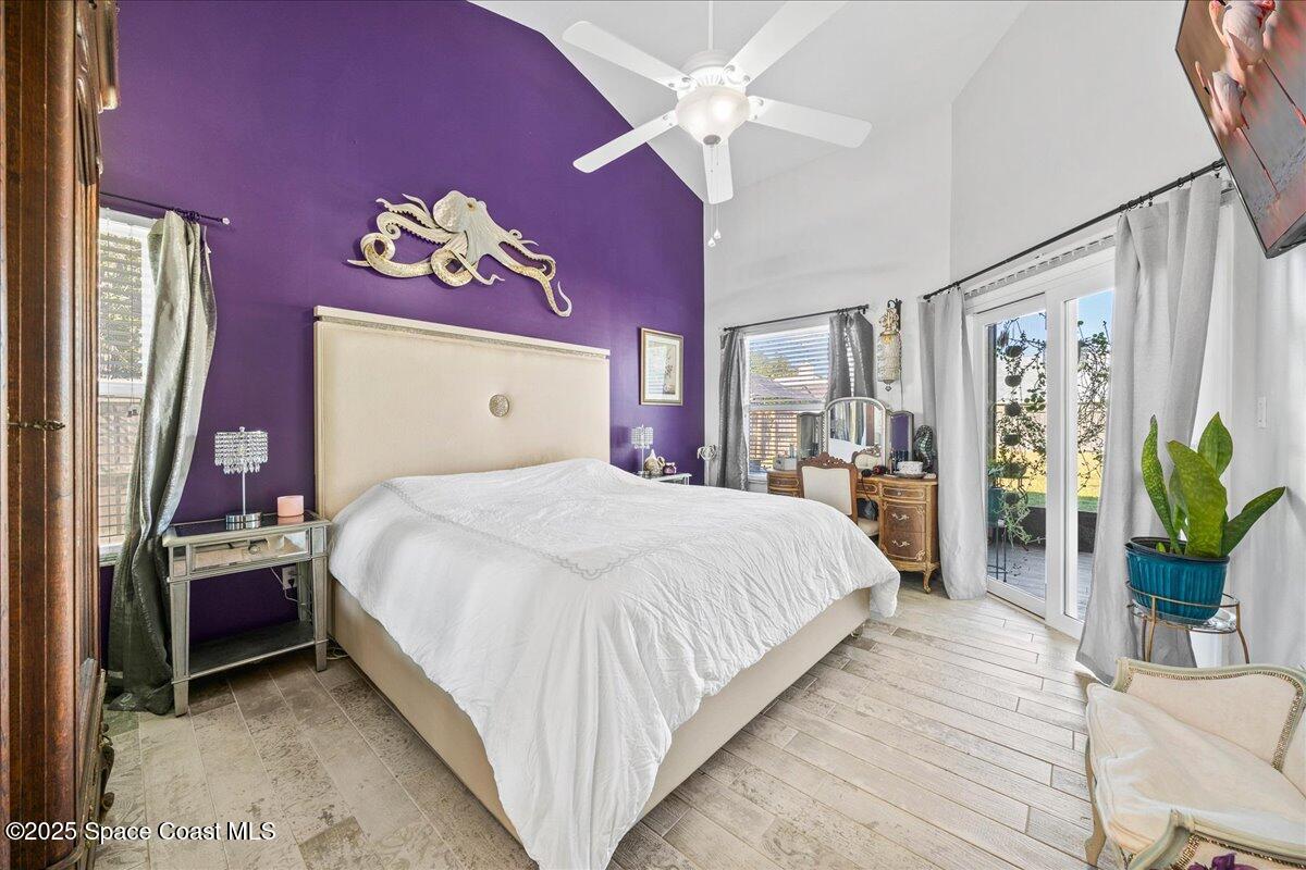 910 Brookshire Circle Malabar, FL 32950 - Photo 12 of 29 a bedroom with a large bed and a chandelier