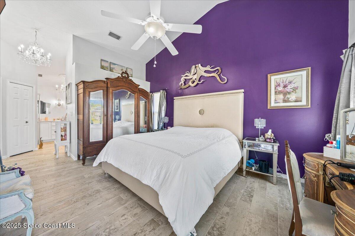 910 Brookshire Circle Malabar, FL 32950 - Photo 13 of 29 a bed room with a bed and a chandelier