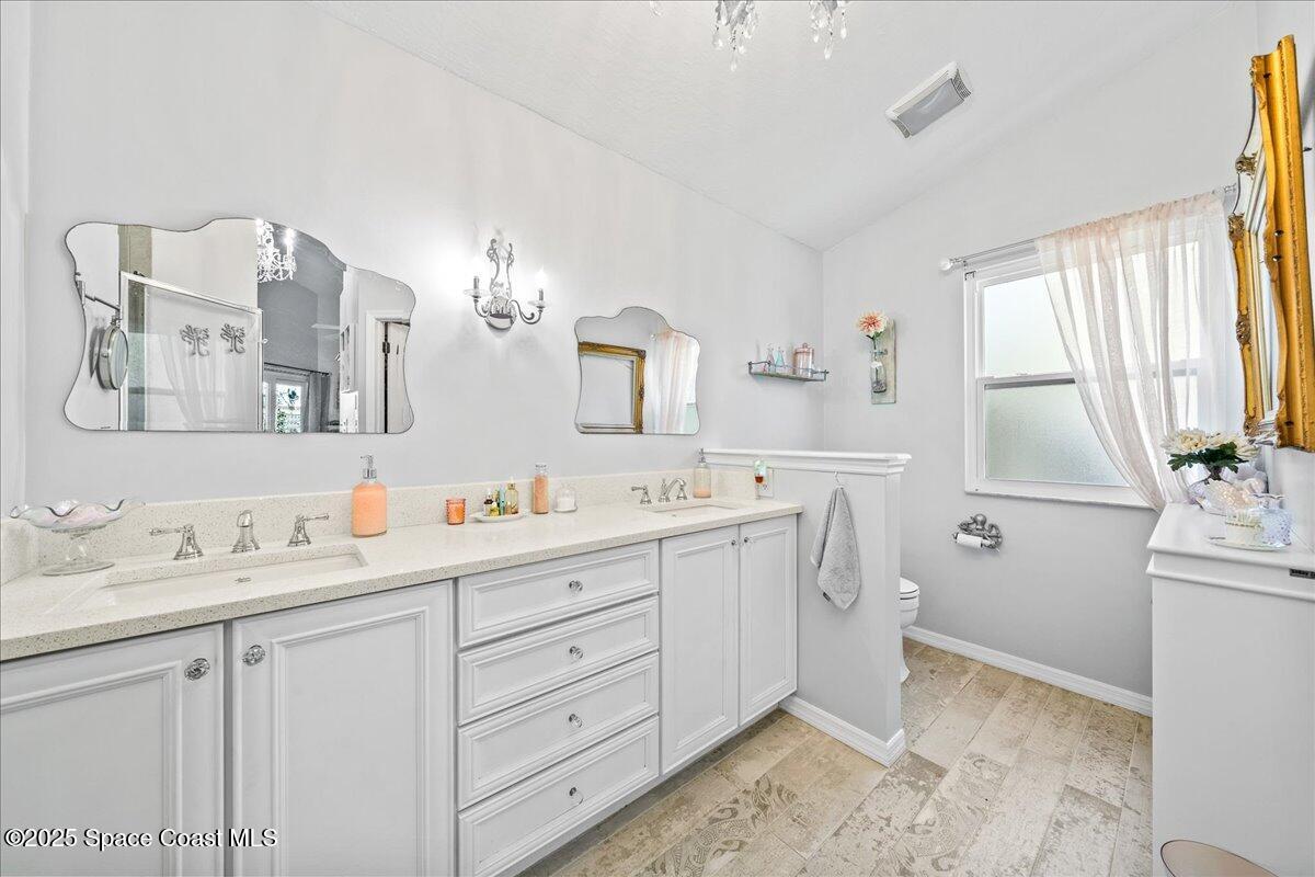 910 Brookshire Circle Malabar, FL 32950 - Photo 14 of 29 a spacious bathroom with a double vanity sink mirror and