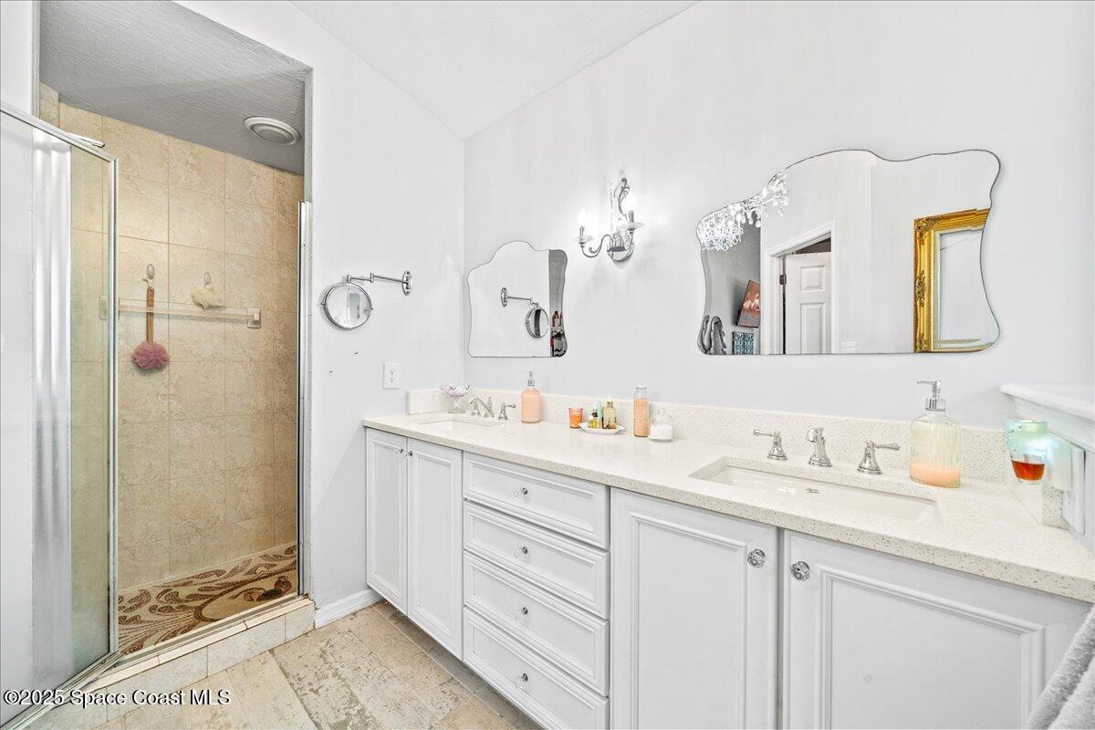 910 Brookshire Circle Malabar, FL 32950 - Photo 15 of 29 a bathroom with a double vanity sink mirror and double