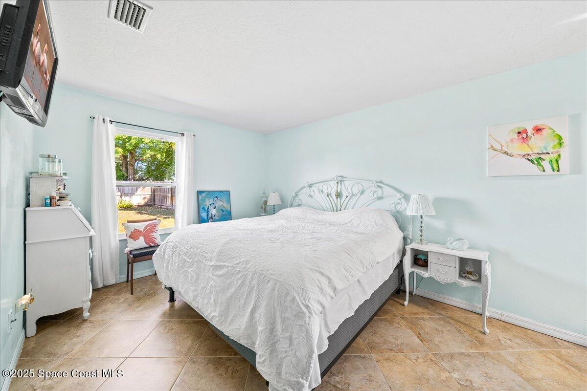910 Brookshire Circle Malabar, FL 32950 - Photo 16 of 29 a bed room with a bed and a tv