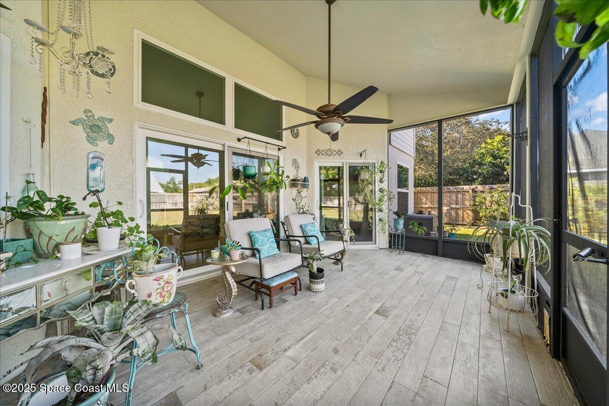 910 Brookshire Circle Malabar, FL 32950 - Photo 20 of 29 a view of a patio with table and chairs potted plants with wooden floor