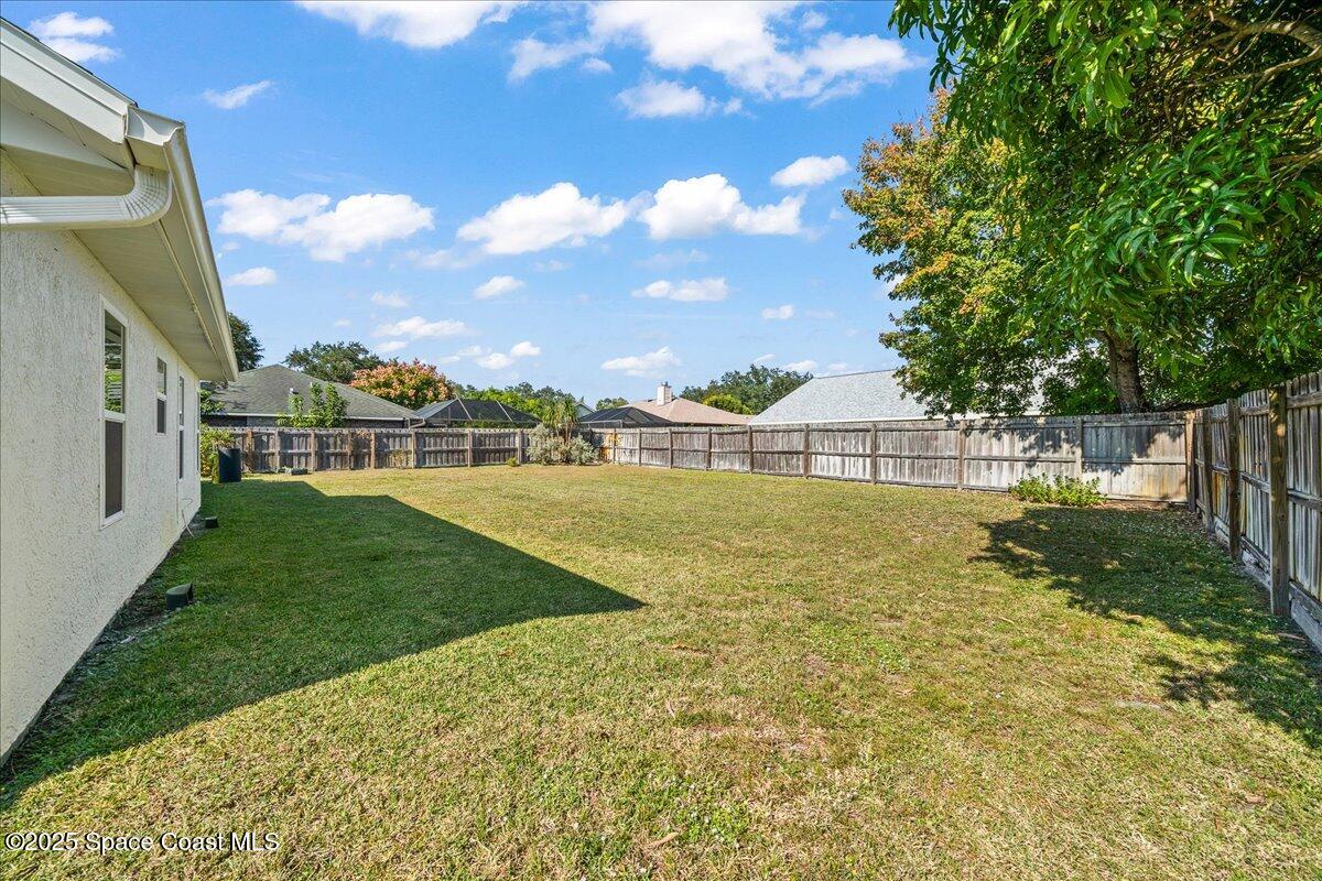 910 Brookshire Circle Malabar, FL 32950 - Photo 22 of 29 a view of yard with swimming pool and green space