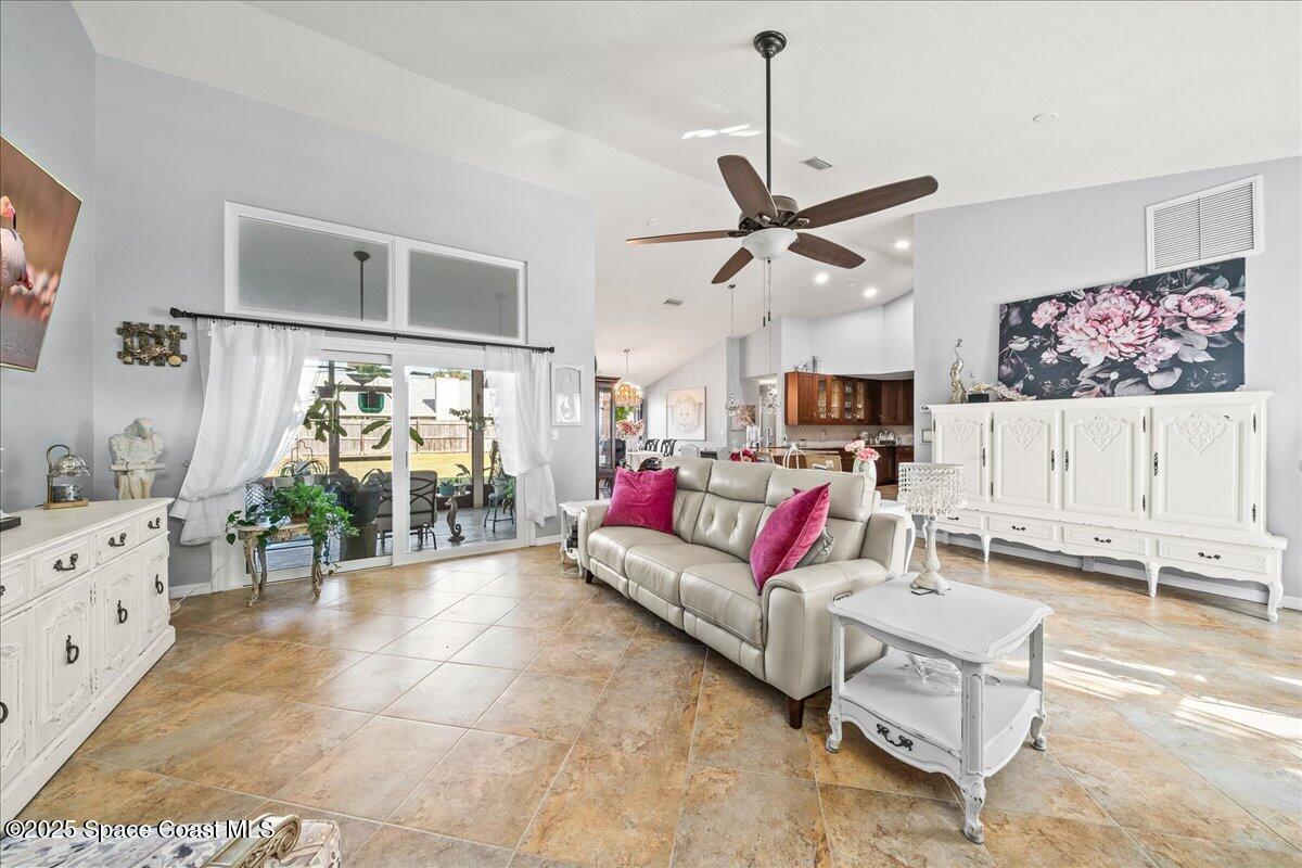 910 Brookshire Circle Malabar, FL 32950 - Photo 3 of 29 a living room with furniture a chandelier and a flat screen tv