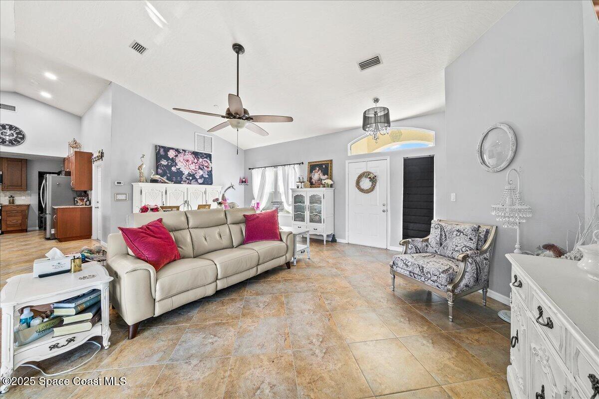 910 Brookshire Circle Malabar, FL 32950 - Photo 4 of 29 a living room with furniture and a chandelier