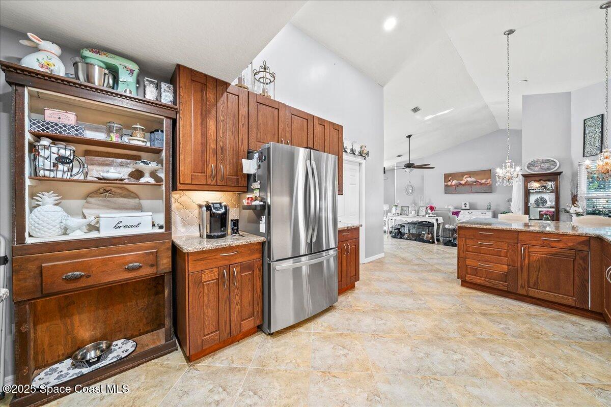 910 Brookshire Circle Malabar, FL 32950 - Photo 7 of 29 a kitchen with stainless steel appliances granite countertop a refrigerator a stove and a sink