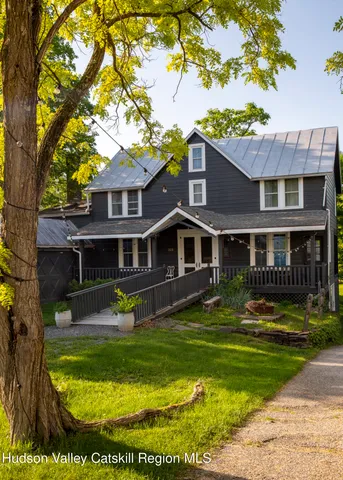 a view of a room with wooden floor and furniture