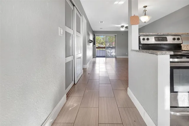 a view of a kitchen with a sink and refrigerator