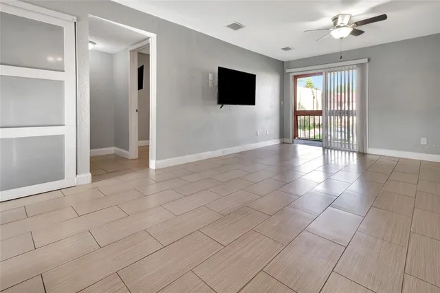 a view of an empty room with glass door