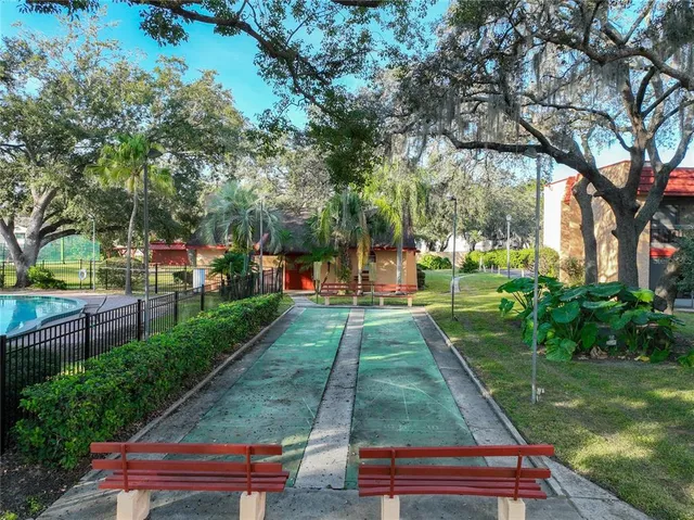 a view of a park with iron fence