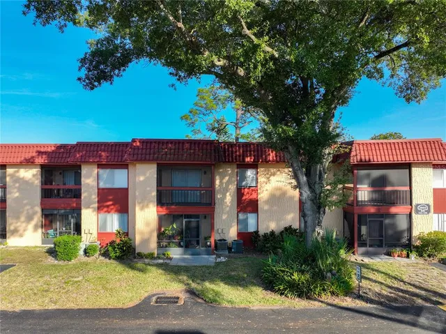a front view of a house with a yard garage and outdoor seating