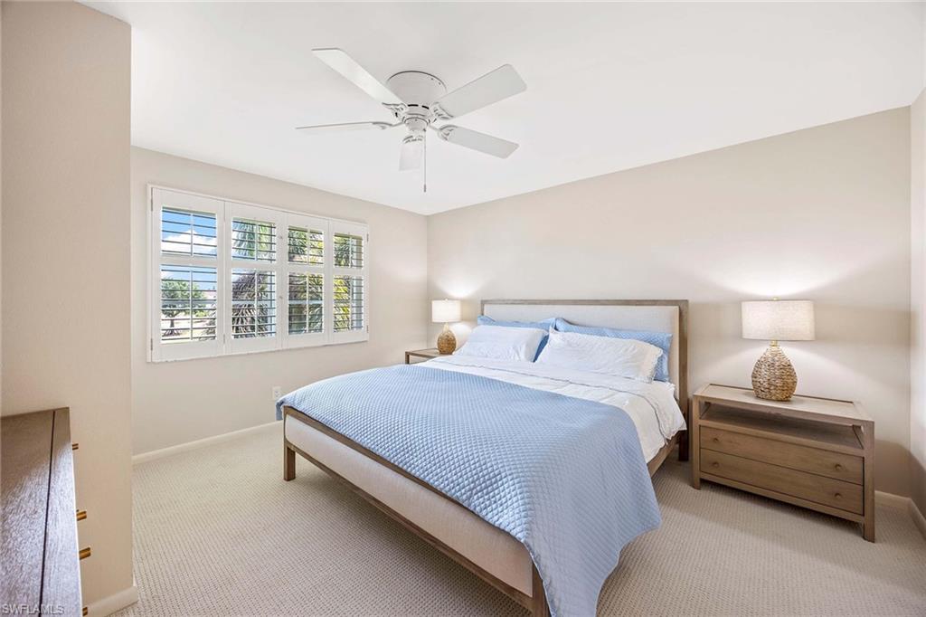 45 High Point Circle South, Unit 303 Naples, FL 34103 - Photo 11 of 22 a bedroom with a bed and a window