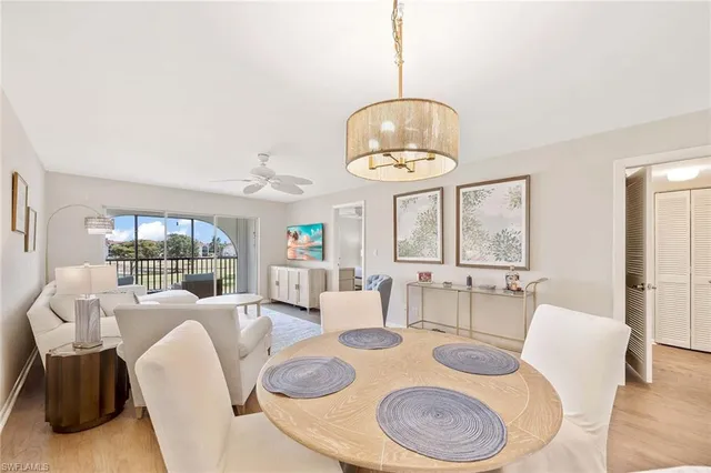 a view of a dining room with furniture wooden floor and chandelier
