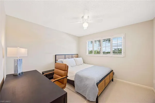 a bedroom with a bed and a lamp